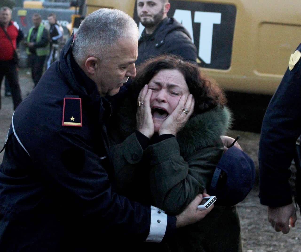 A woman cries as her relatives are trapped in a building after an earthquake hit Thumane, Albania.