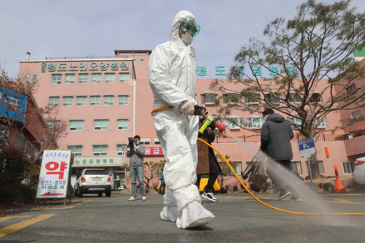 A worker wearing protective gears sprays disinfectant against the coronavirus in South Korea.