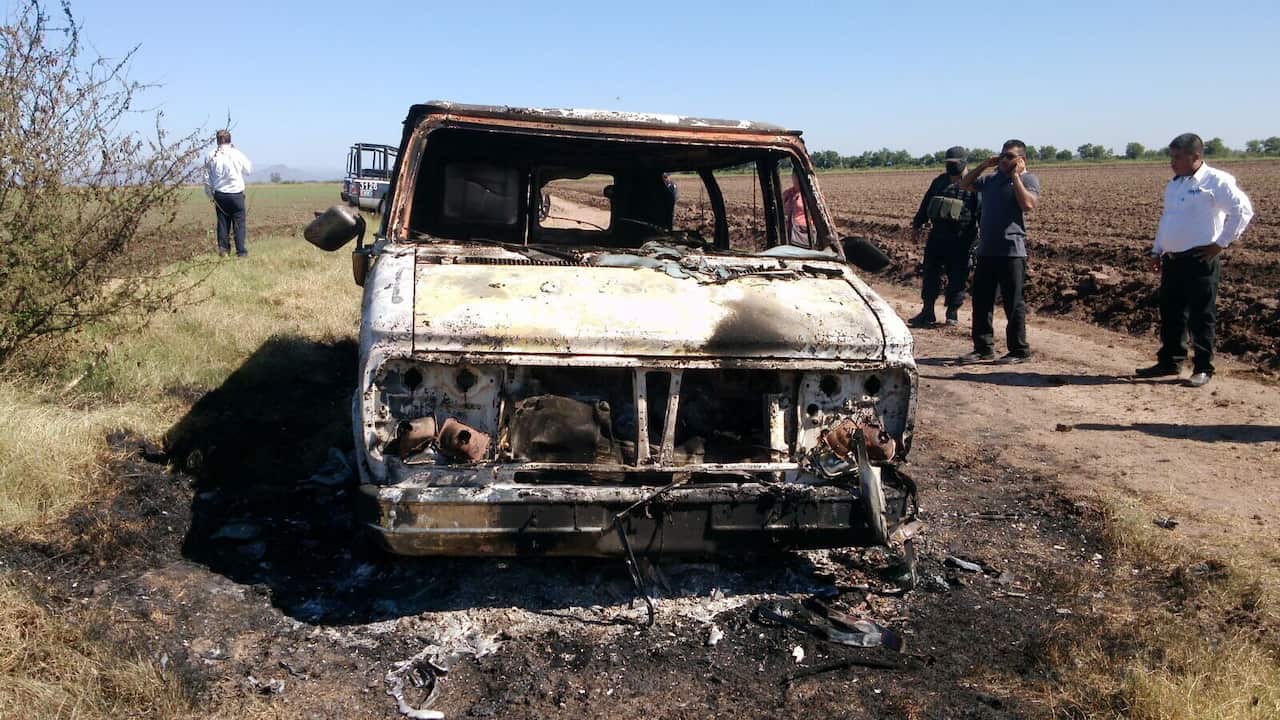 In this Nov. 21, 2015 photo, Mexican authorities inspect a burnt out van suspected to belong to a couple of Australian tourists missing for more than a week, in Sinaloa, Mexico.  (AP Photo)