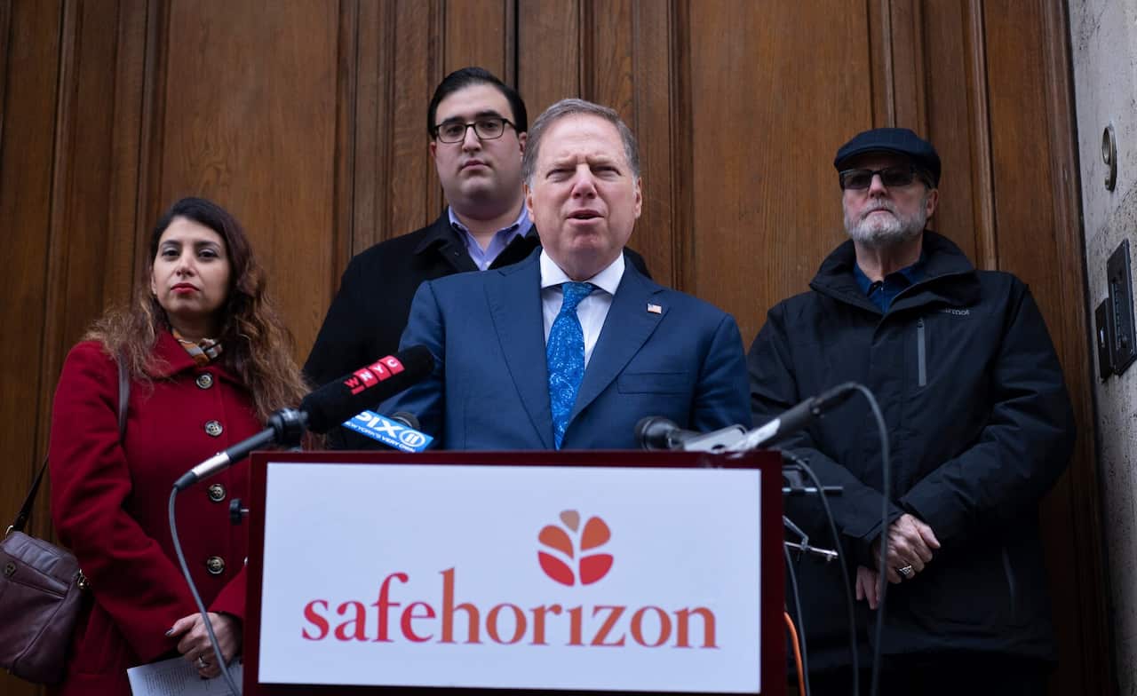 U.S. Attorney Geoffrey Berman, standing outside Jeffrey Epstein's Manhattan home with victims of childhood sexual abuse 