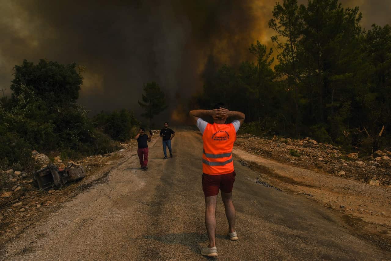 People flee a fire at Sirtkoy village, near Manavgat in Turkey. 