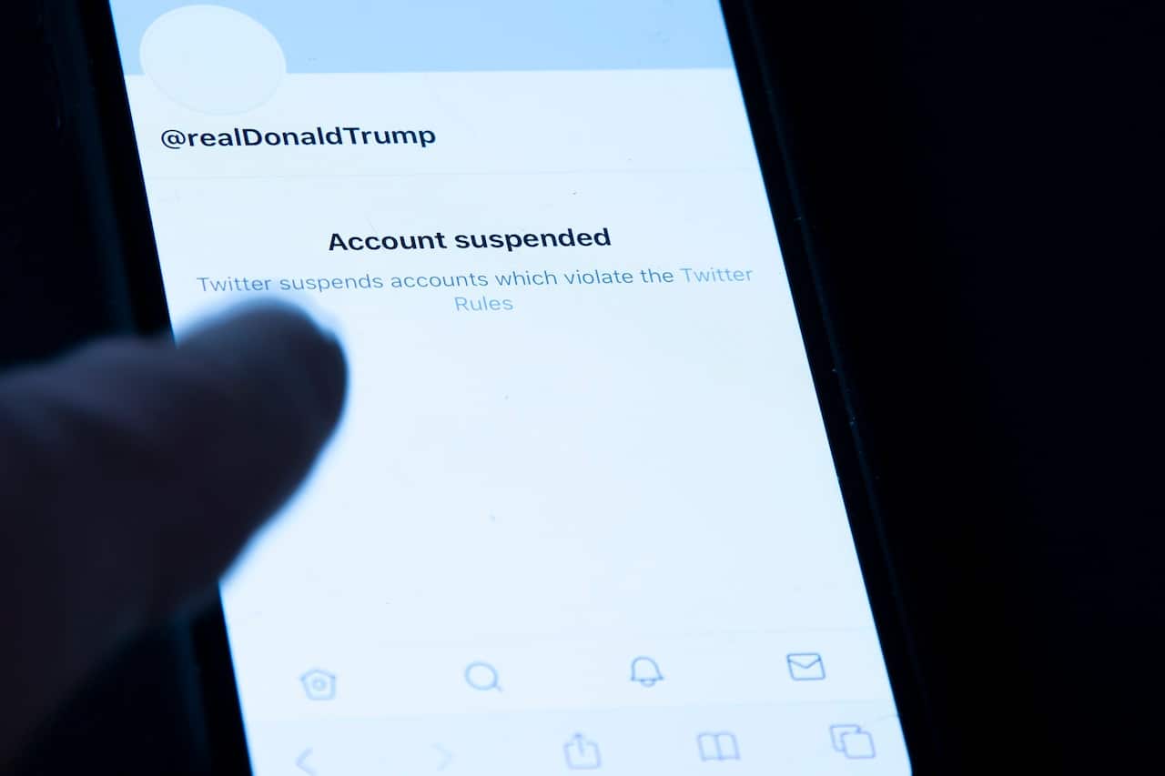 President Donald Trump's suspended Twitter account is seen on a mobile phone
