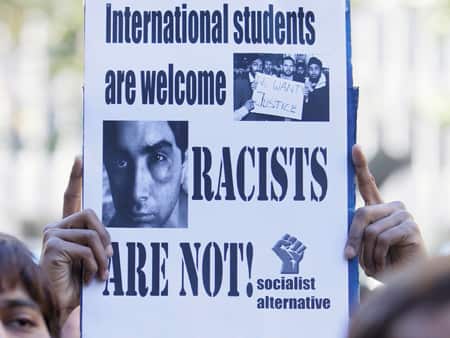 An Indian student holds a protest sign during a rally to stamp out violence against international students and racism in Sydney, Australia, Sunday, June 7, 2009.(AP Photo/Rob Griffith)