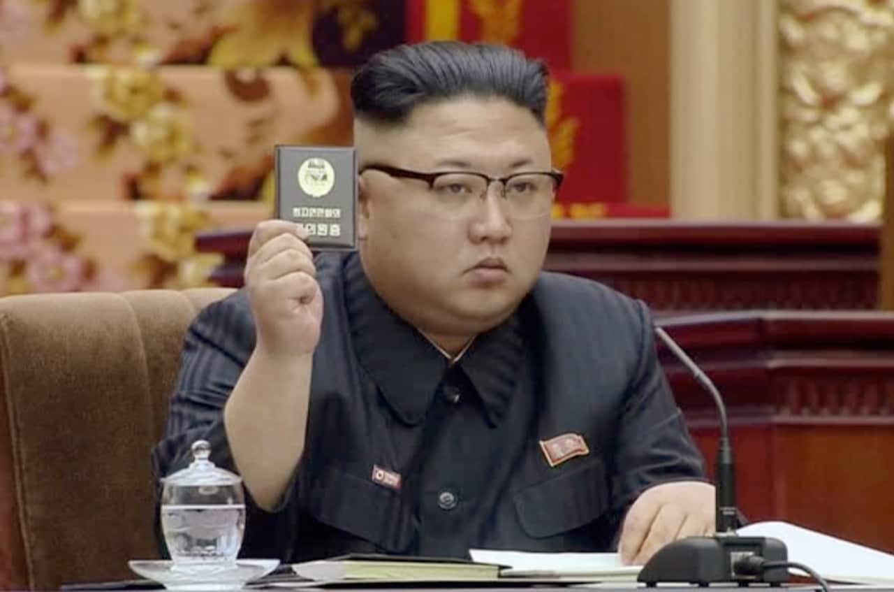 North Korean leader Kim Jong Un holds up the Supreme People's Assembly card in Pyongyang