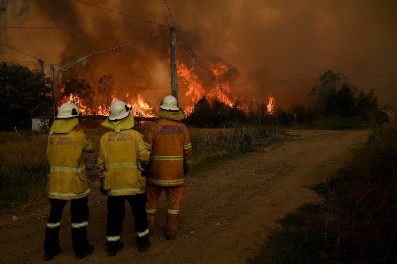 NSW Rural Fire Service crews watch on as on as the Gospers Mountain Fire impacts the Bilpin Fruit Bowl, in Bilpi