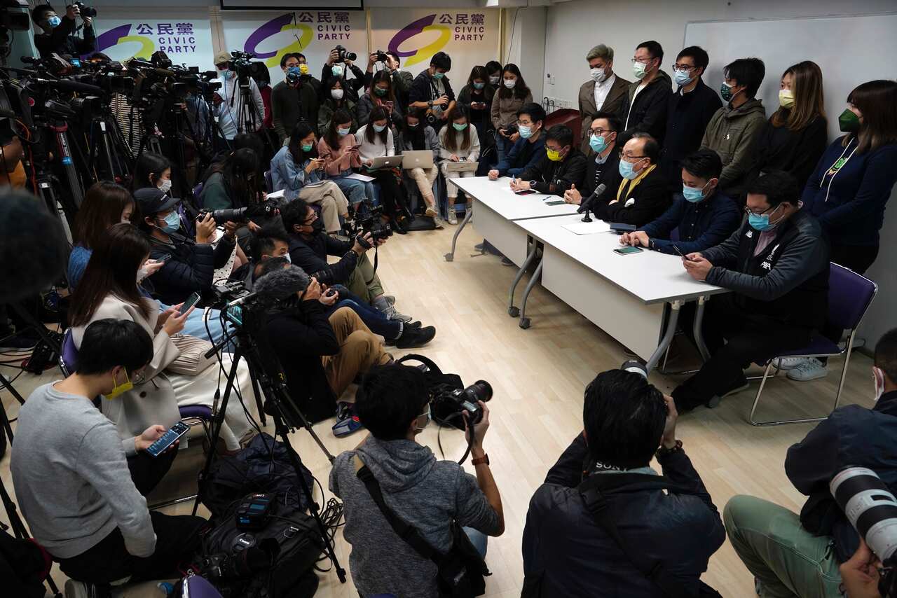 Pro-democratic party members respond to mass arrests during a press conference in Hong Kong.