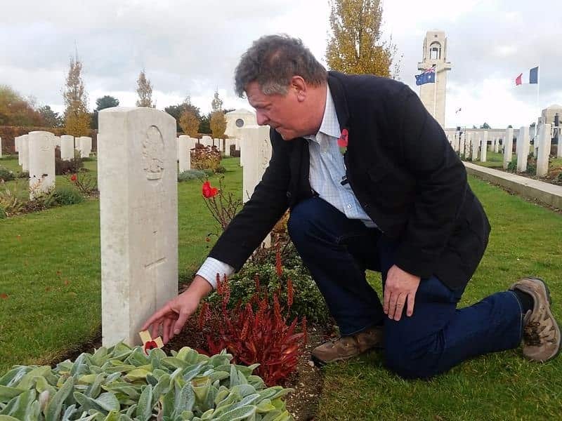 Australian Stephen Walls lays a tribute on a grave.