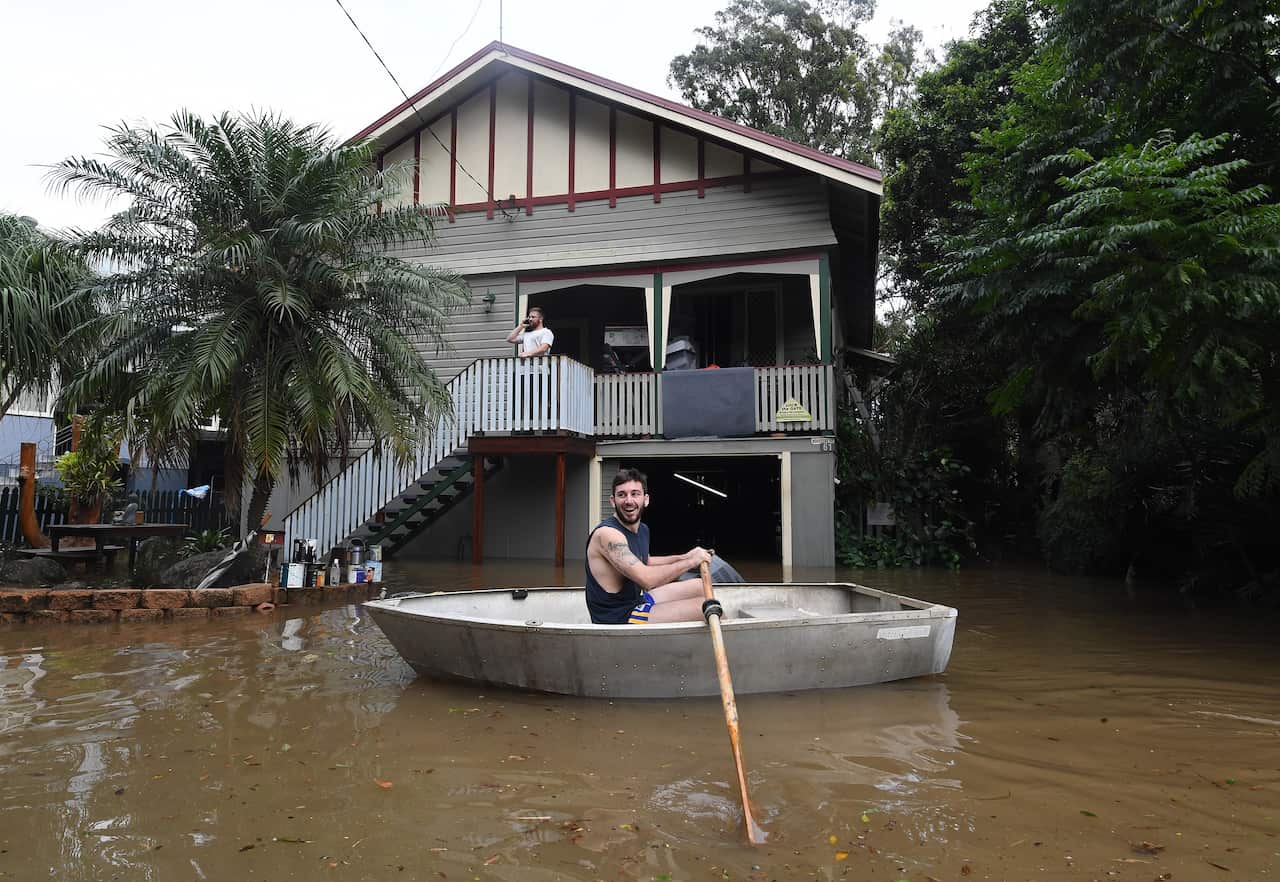 Lennon Bartlett rows a boat to his parents' house in central Lismore