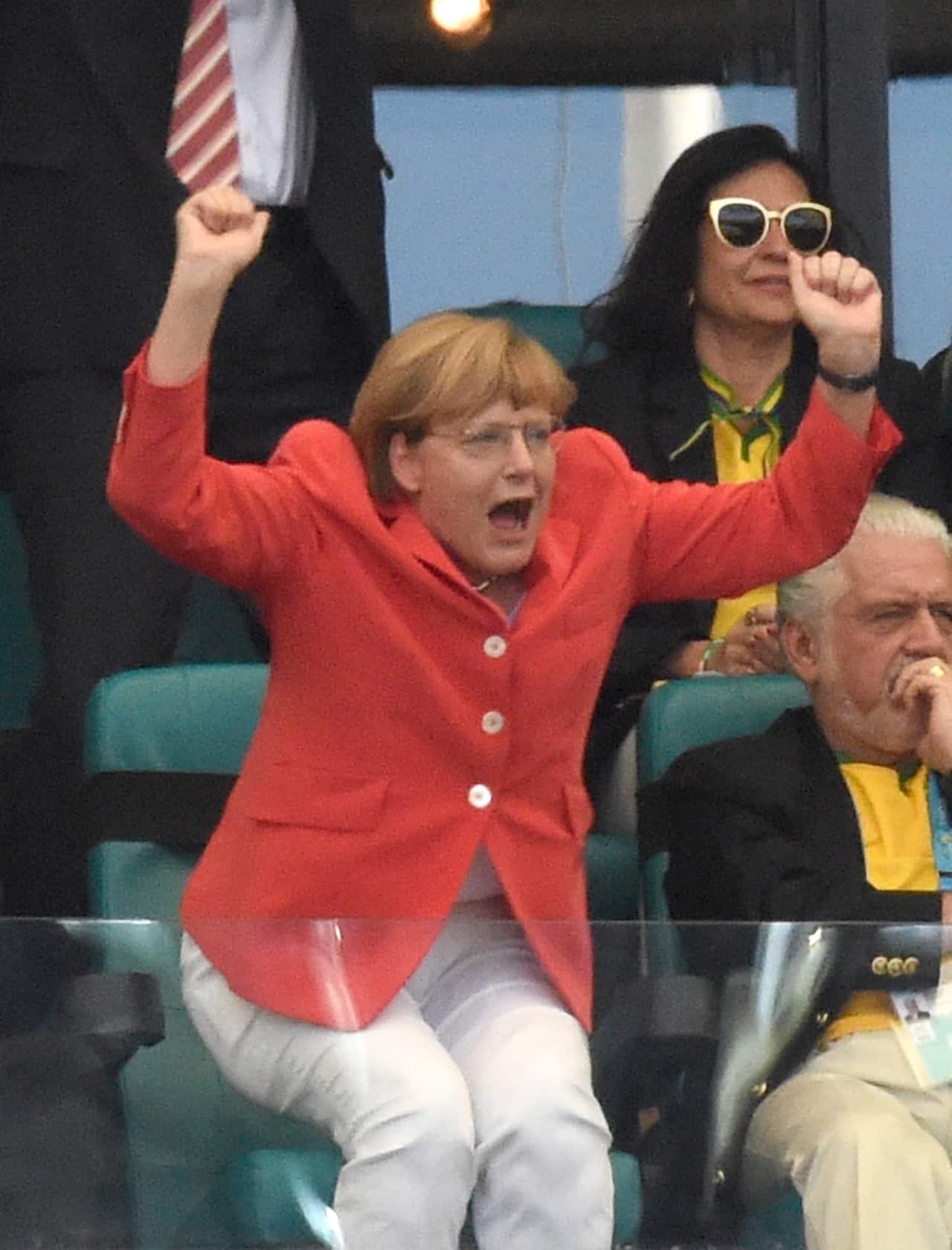 Angela Merkel celebrates Germany's 2-0 goal during the FIFA World Cup 2014 match between Germany and Portugal