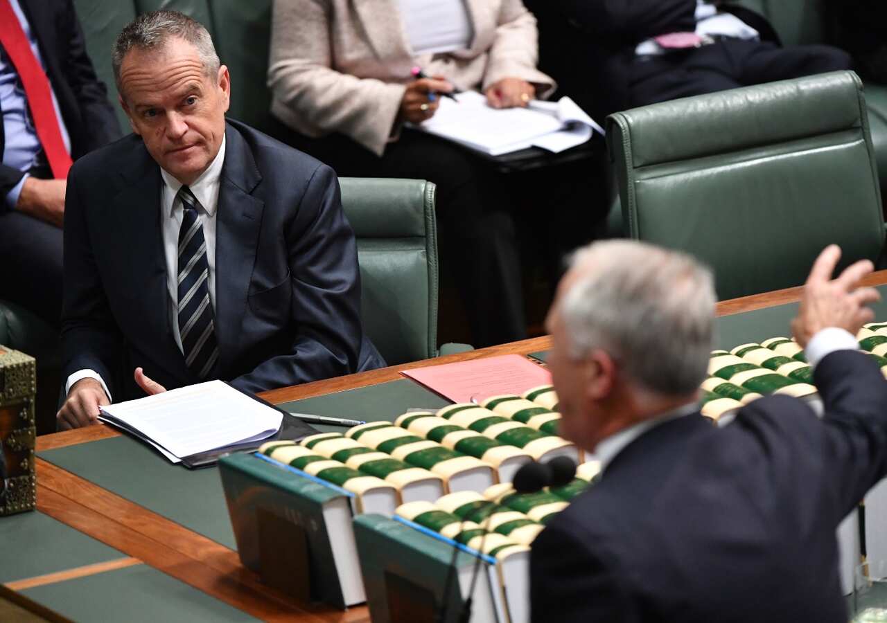Leader of the Opposition Bill Shorten listens to Prime Minister Malcolm Turnbull during Question Time in the House of Representatives at Parliament House in Canberra, 