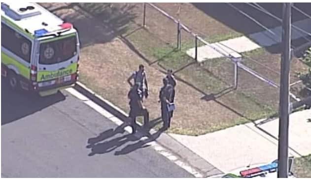 Emergency services workers at the scene in Logan after two young girls were found dead in a car. ABC / Twitter