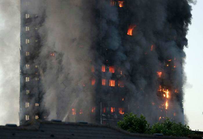 Smoke and flames rise from building on fire in London