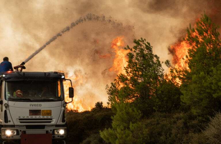 A firefighter battles the flames in Athens, Greece, on 6 August, 2021