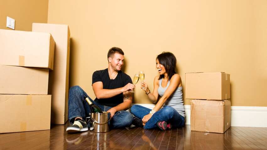 Two young people celebrate their first home.