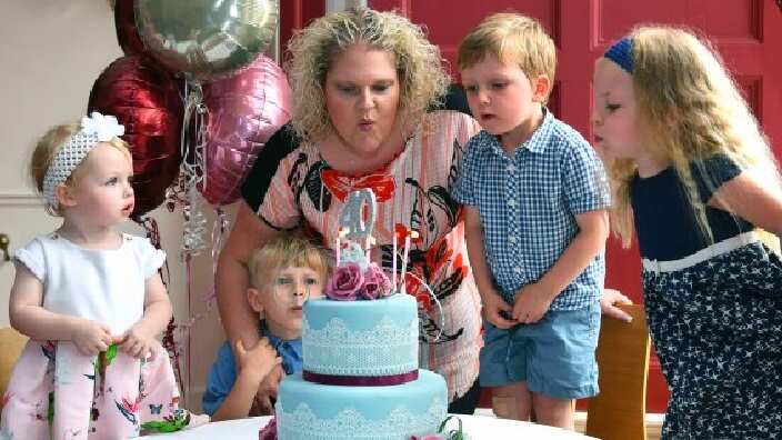 Louise Brown blows out candles on a 40th birthday cake