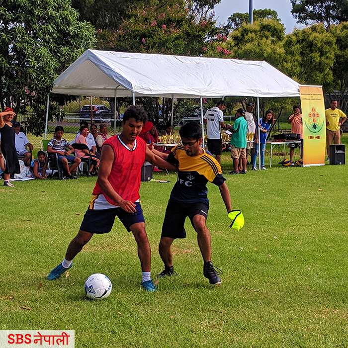 Bhutanese youths playing soccer during a community sporting event