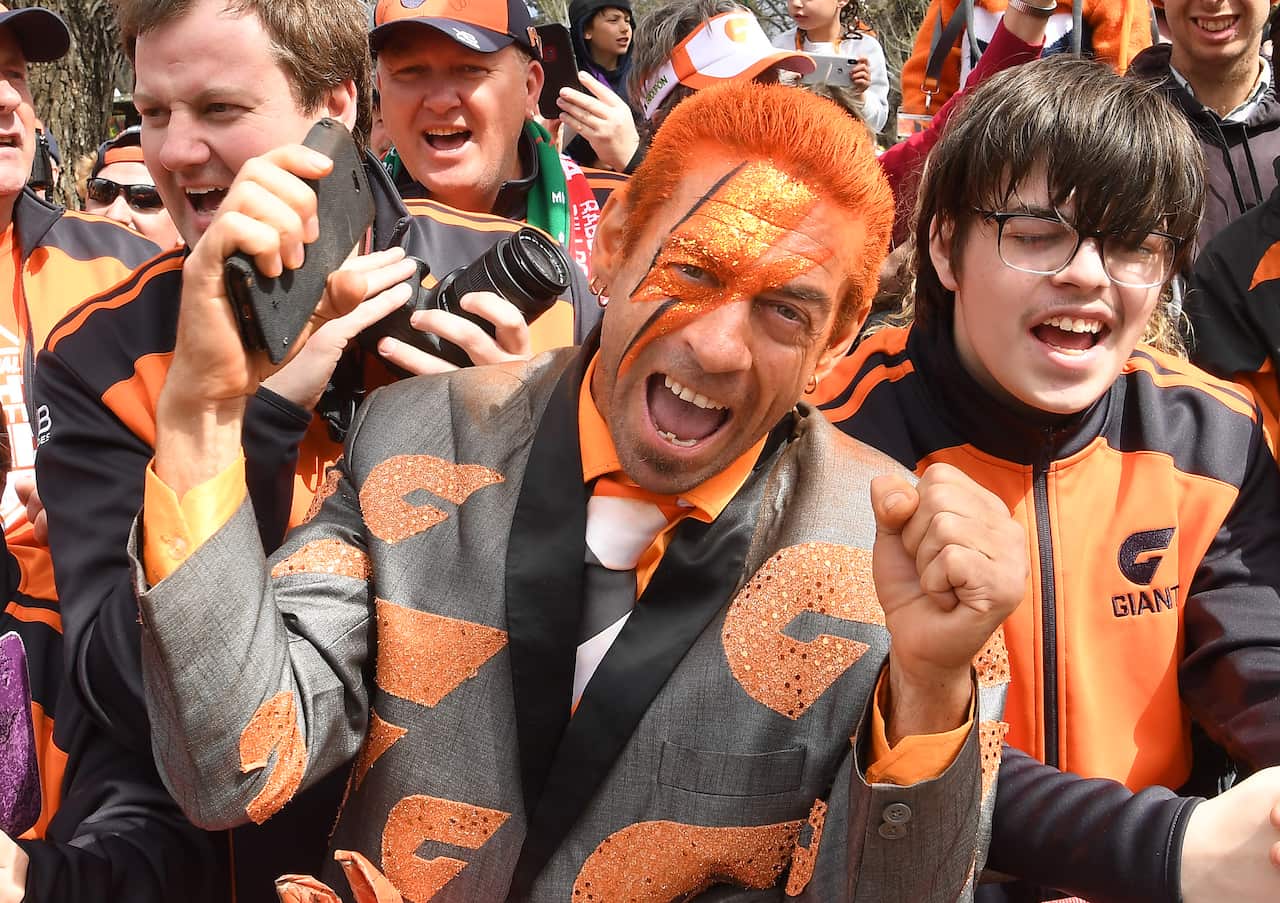 GWS fans are seen during the AFL Grand Final Parade in Melbourne, Friday, September 27, 2019. The Richmond Tigers play the GWS Giants in tomorrow's AFL Grand Final. (AAP Image/Julian Smith) NO ARCHIVING