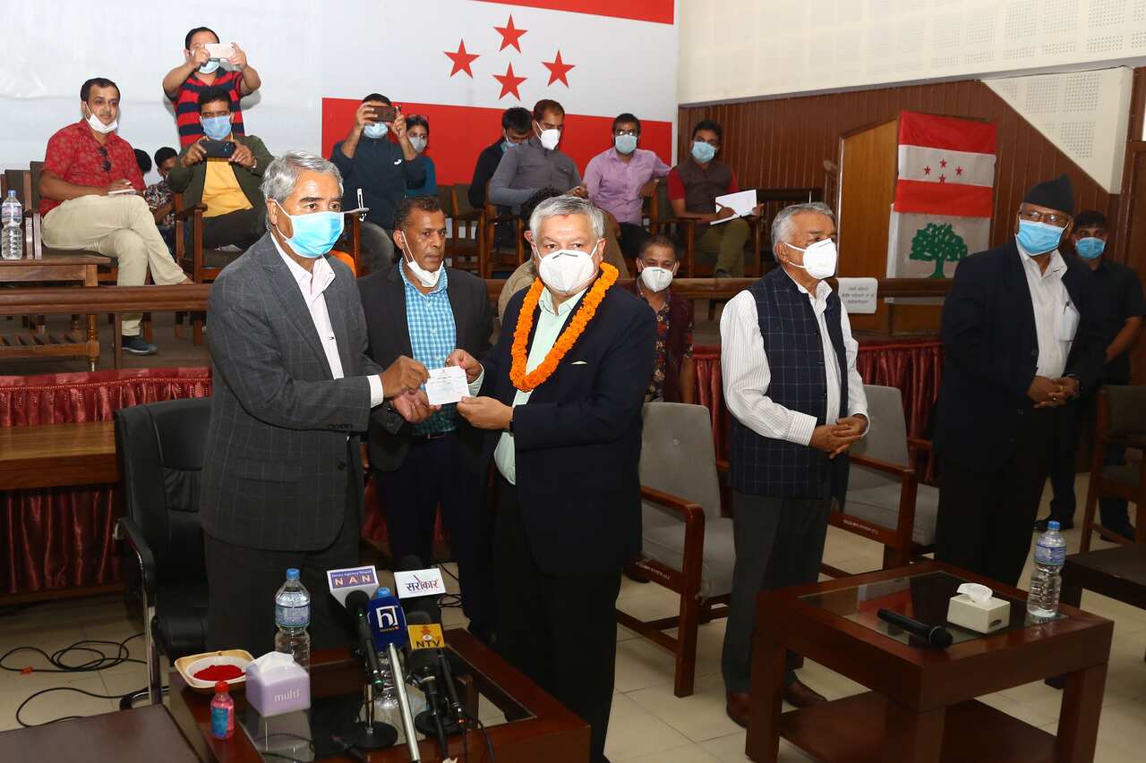Former RPP politicians who joined Nepali Congress being officially welcomed by leader Sher Bahadur Deuba