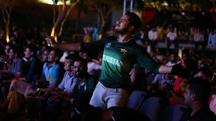 People watch the cricket match between India and Pakistan on a big screen in Karachi, Pakistan, 16 June 2019.