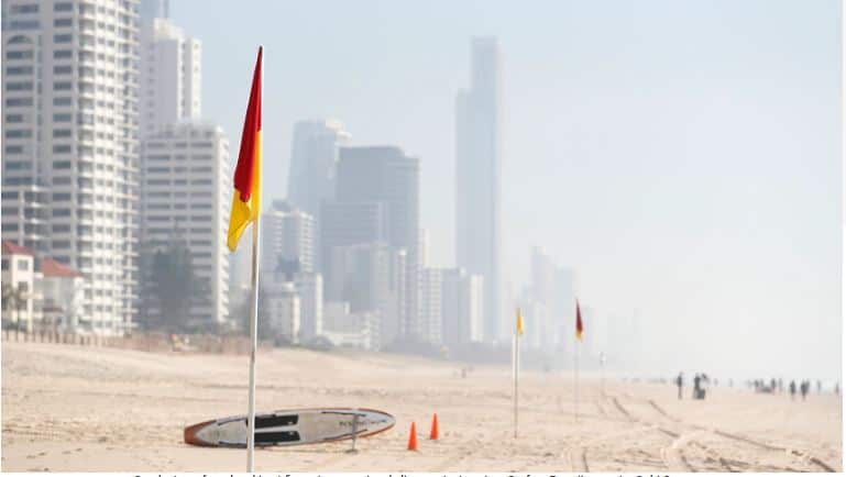 Smoke haze from local bushfires obscures the skyline on the beach at Surfers Paradise on the Gold Coast on Thursday. Source: AAP