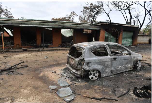 A house and car damaged by last Saturday's catastrophic bushfires in the Southern Highlands village of Balmoral. AAP