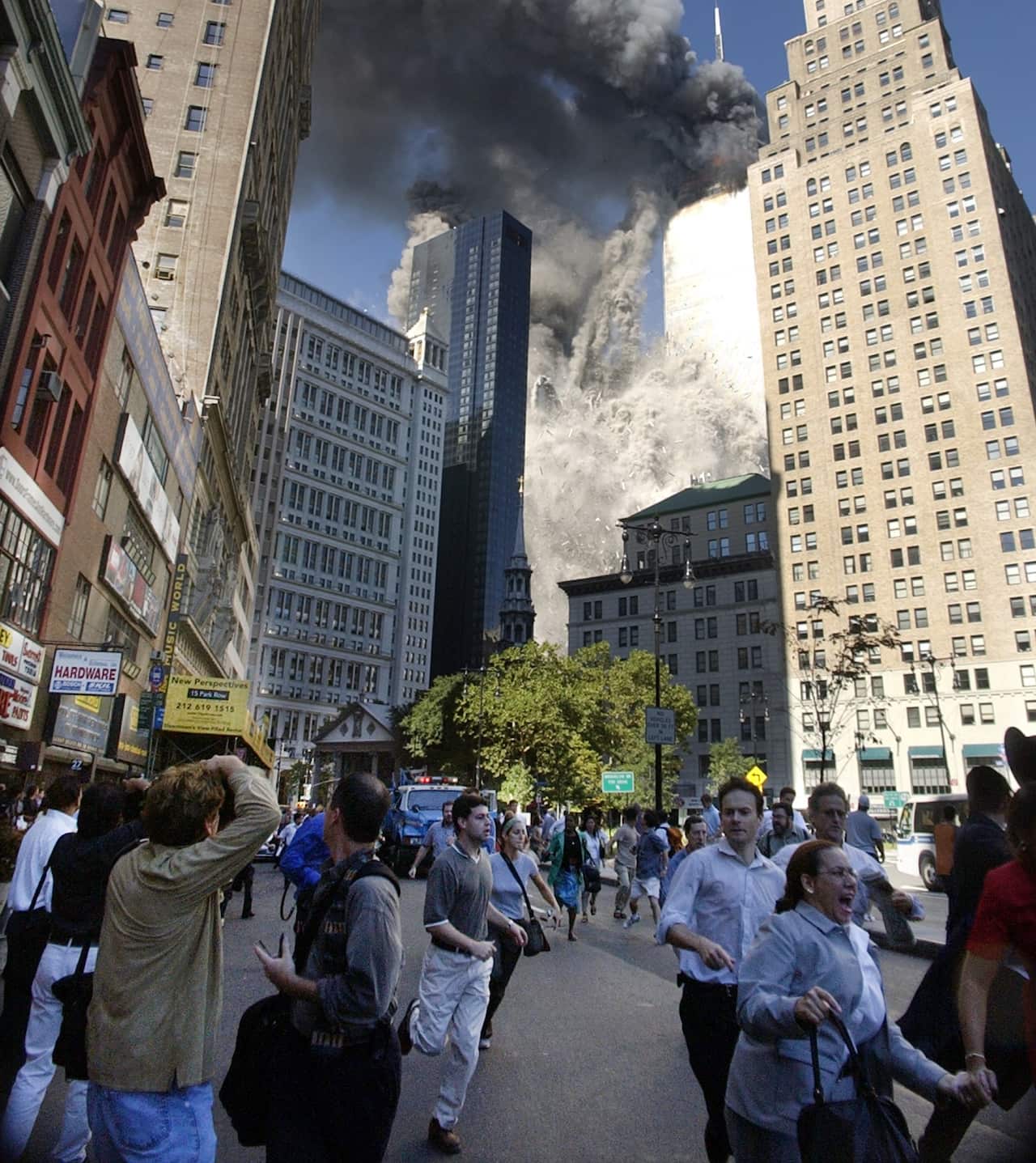 People flee the falling South Tower of the World Trade Center on Tuesday, September 11, 2001.