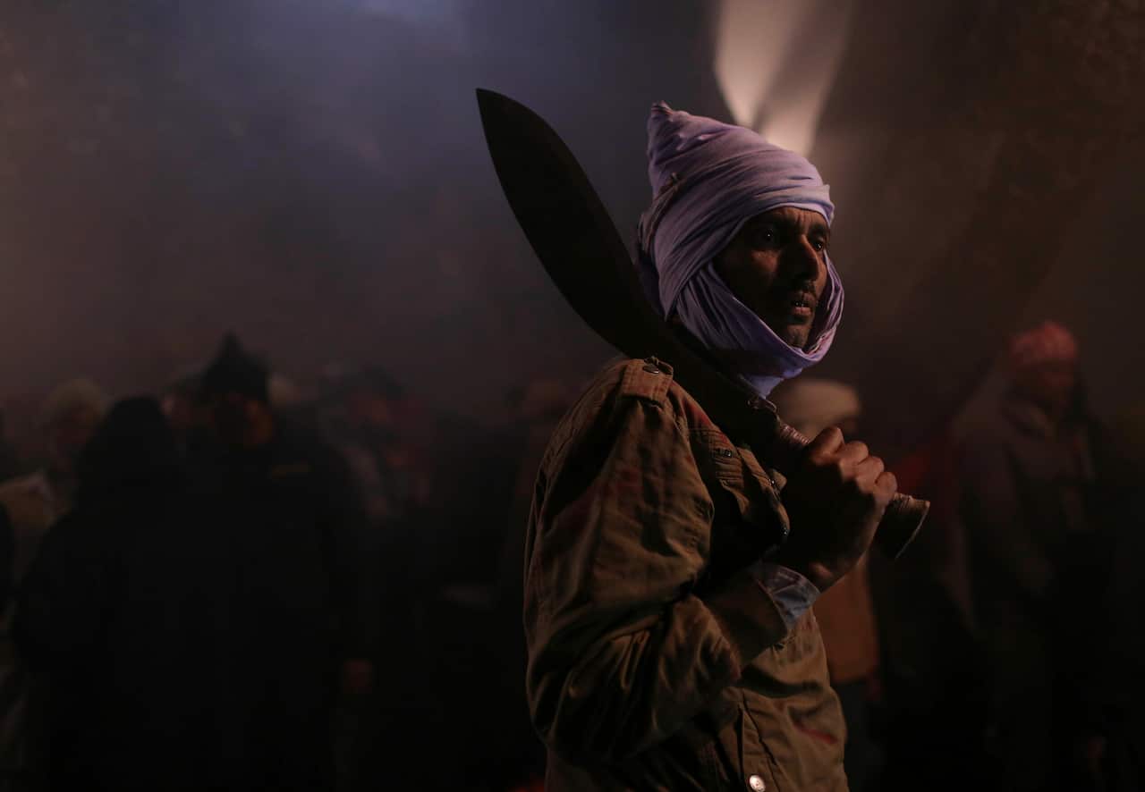 A butcher gets ready to sacrifice animals during Gadhimai festival in Bariyarpur in Bara district 80 miles (50 miles) south of Kathmandu, Nepal,