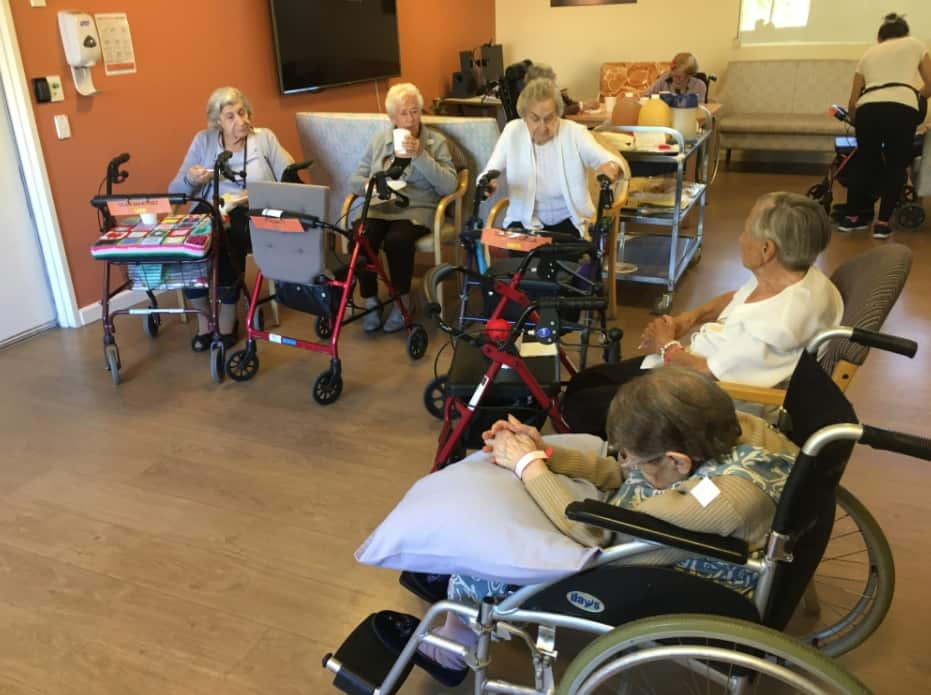 A group of residents at Residential Gardens wait to receive their dose of the COVID vaccine.