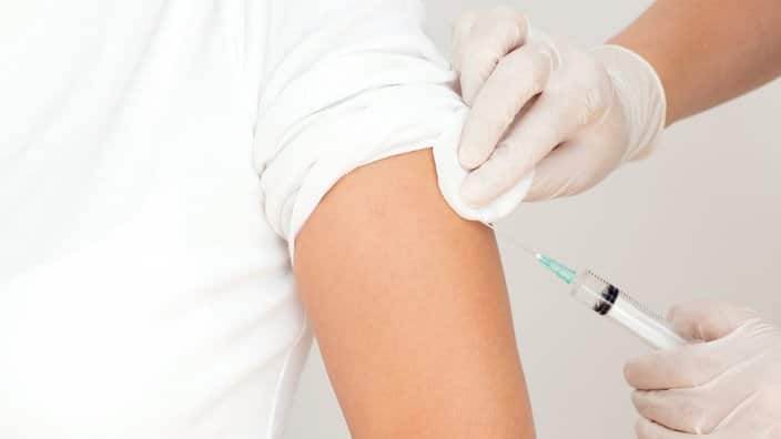 Nurse makes vaccination of patient in a clinic, horizontal