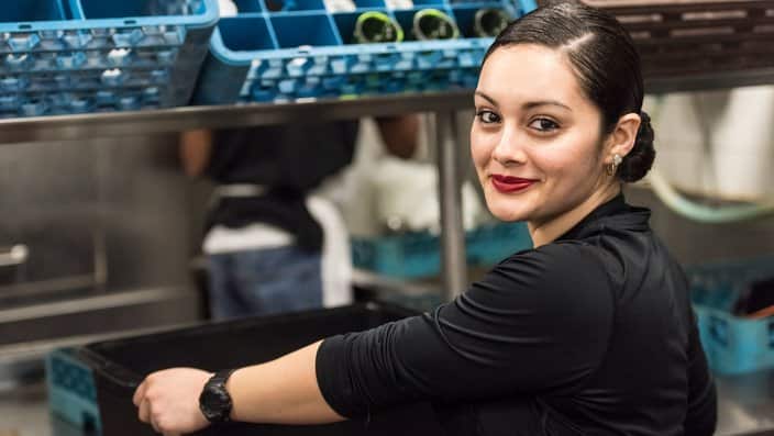 Smiling Young hispanic female kitchen worker looking at the camera Young hispanic female kitchen worker