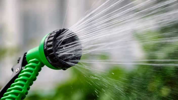 Garden sprinkler for irrigation plants with jets of water. Frozen motion