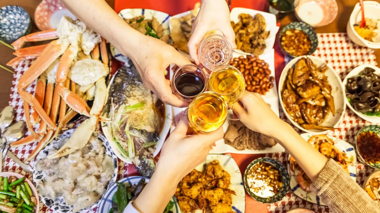 Family are toasting beers and wines over Chinese traditional dishes celebrating for Chinese new year, Tokyo, Japan.