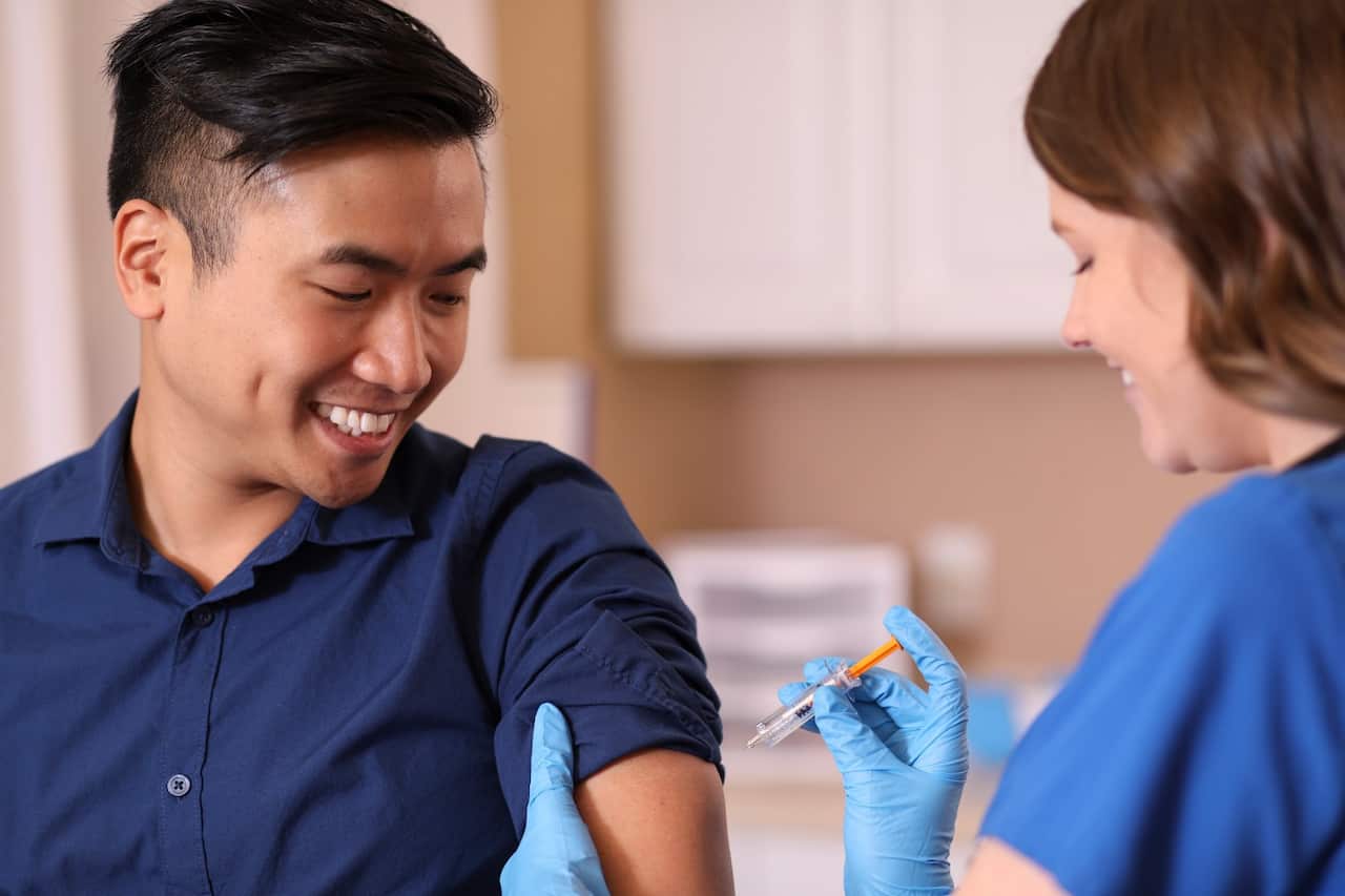 Young man getting flu shot