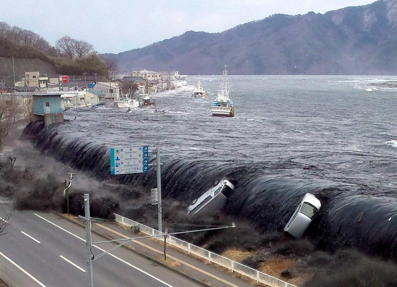 The tsunami breeches an embankment in the city of Miyako in Iwate prefecture shortly after a 9.0 magnitude earthquake hit the region of northern Japan. 