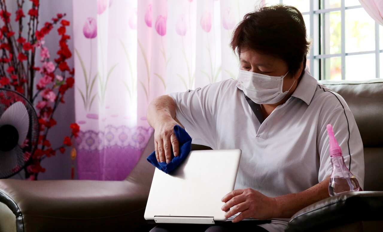 woman cleaning laptop