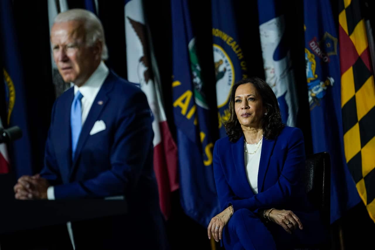 Democratic presidential candidate Joe Biden (L) speaks as running mate Kamala Harris looks on, August 12, 2020 in Wilmington, Delaware.