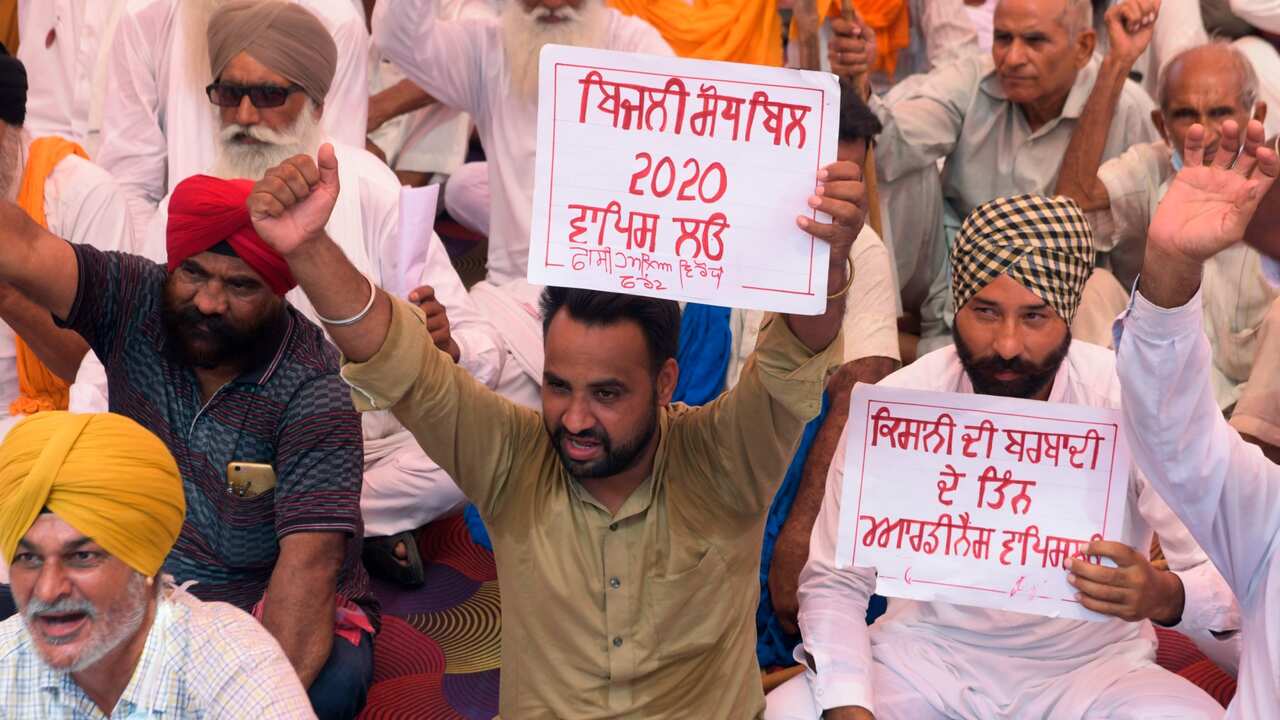Farmers shout slogans against Indian Prime Minister Narendra Modi's government during a nationwide farmers' strike following the recent passing of agriculture bills