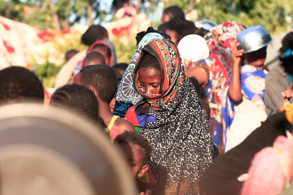 Ethiopian refugees who fled fighting in their homeland of Tigray, wait for their ration of food in the border reception centre of Hamdiyet, in Eastern Sudan.
