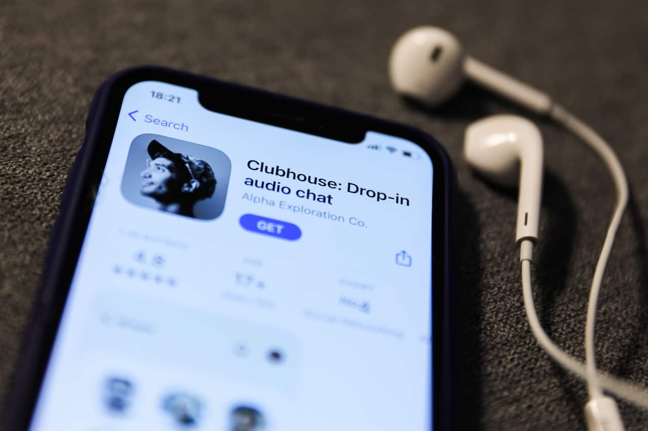 Clubhouse Drop-in audio chat app logo on the App Store is seen displayed on a phone screen.