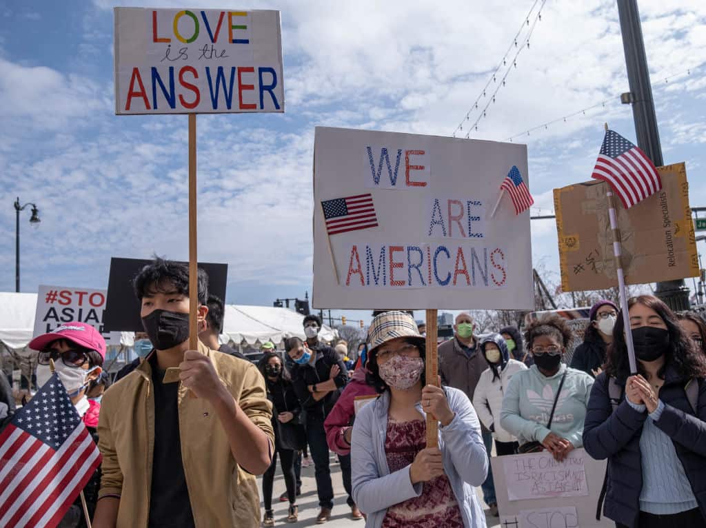 People hold up signs at a Stop Asian Hate rally in Michigan
