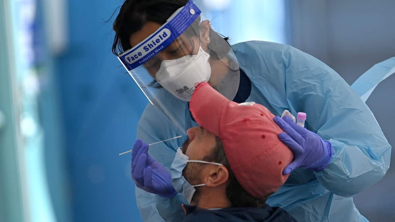 A health worker collects swab samples from a resident at a Covid-19 testing clinic in Sydney on July 17, 2021