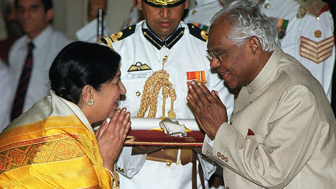 India's renowned playback singer Lata Mangeshkar (L) and the Indian President K.R. Narayanan (R) greet each with the traditional Indian "namaste" prior to the conferment of India's highest civilian award - the Bharat Ratna.
