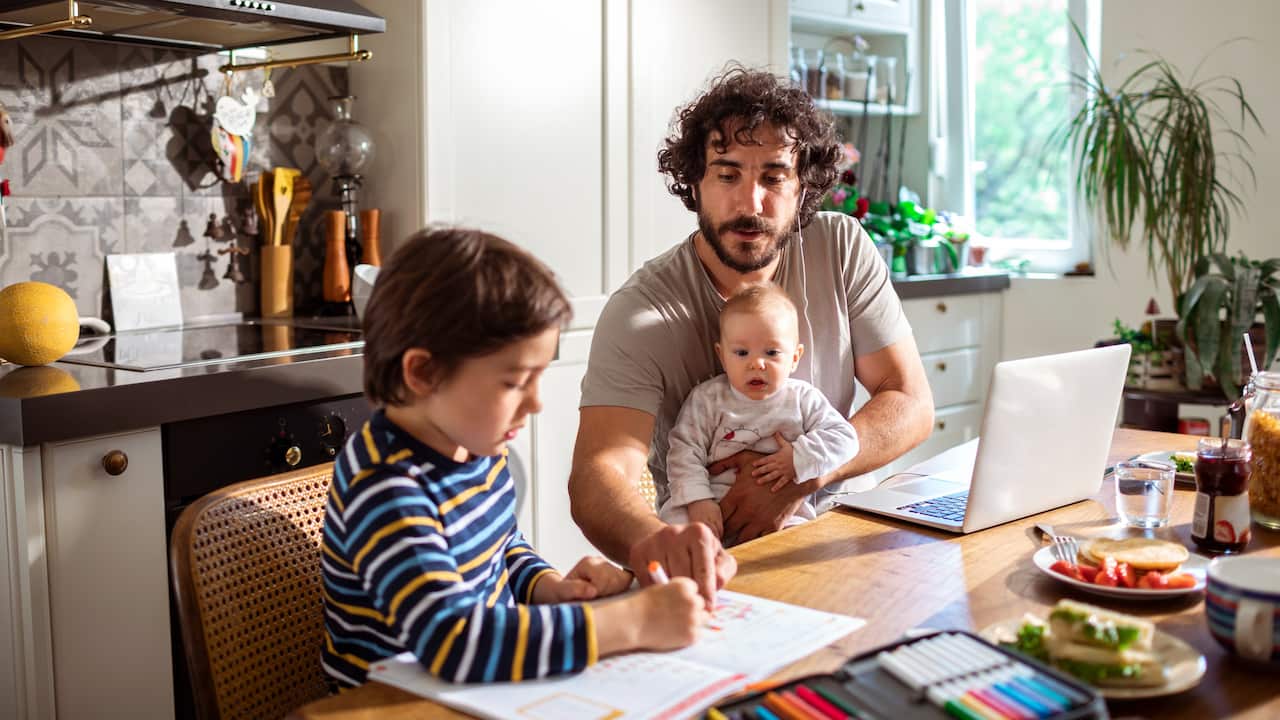 Father working from home with his kids