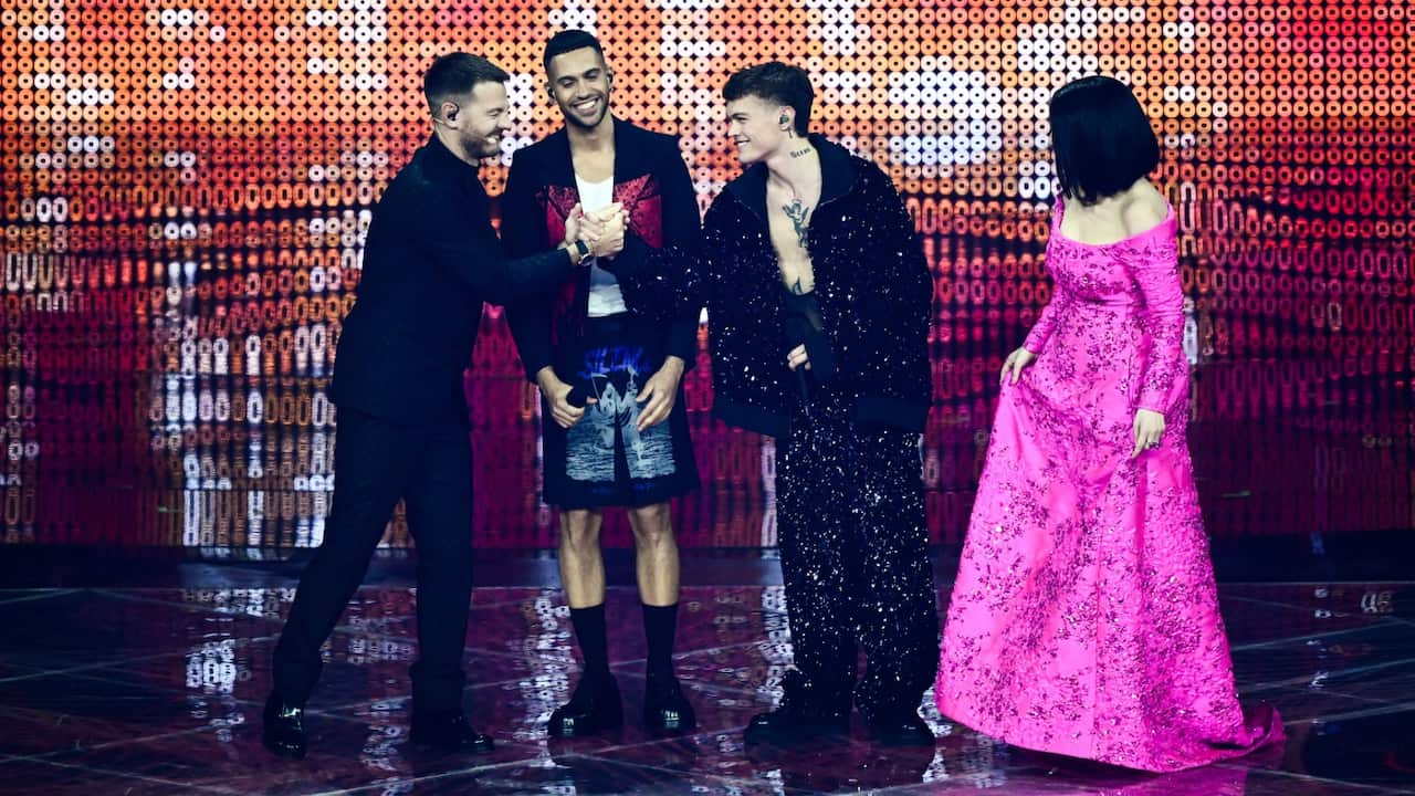 Eurovision 2022 presenter Alessandro Cattelan (L) taps hand with Italian singer Blanco (2ndR) as Italian singers Mahmood (2ndL) and Laura Pausini