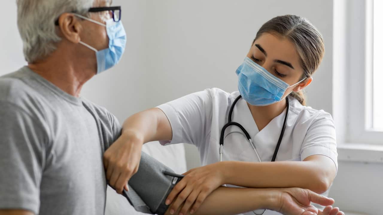 Woman patient and doctor checking blood pressure