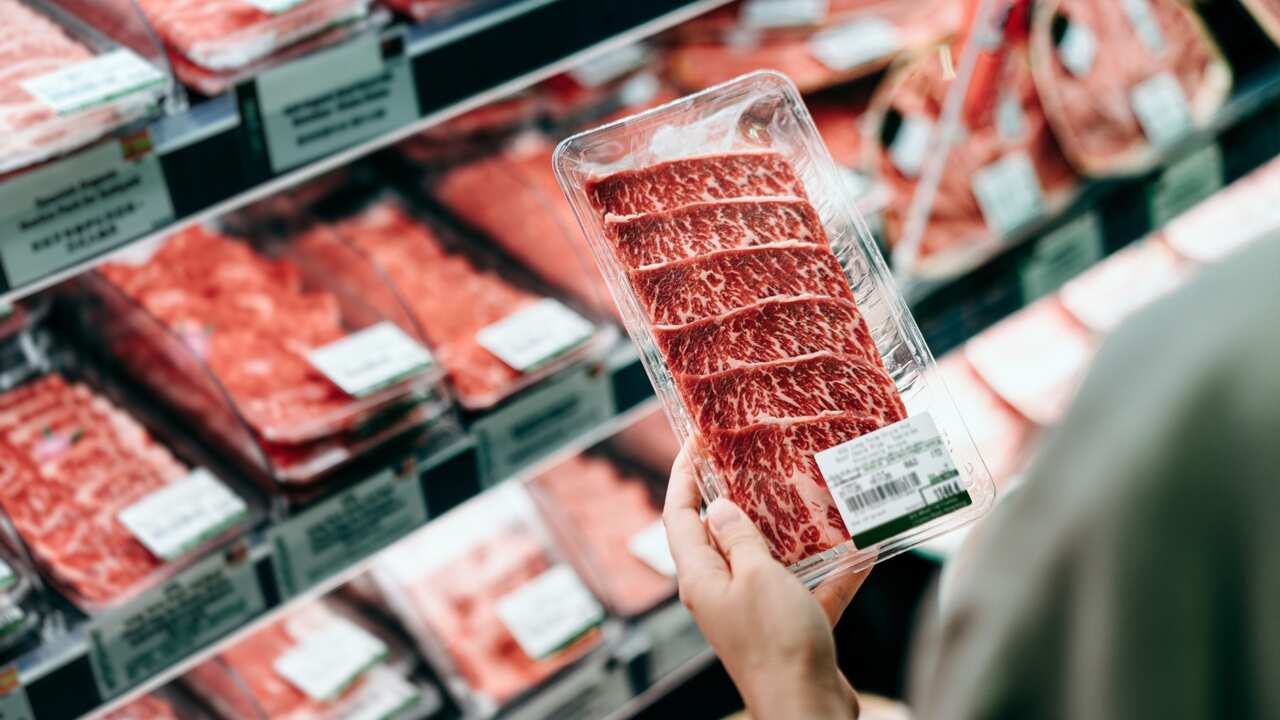 Man looking at meat at supermarket