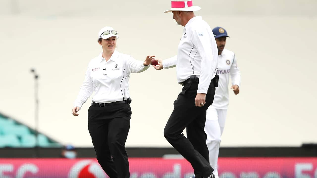 Reserve umpire Claire Polosak takes the old ball from umpire Paul Wilson during day two of the Third Test match in the series between Australia and India