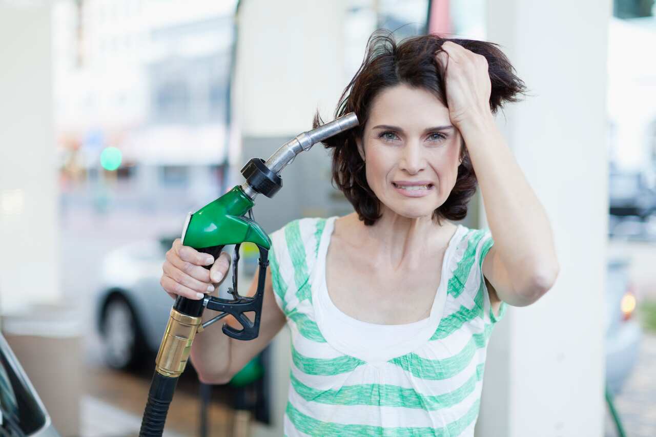 Frustrated woman pumping gas into hair
