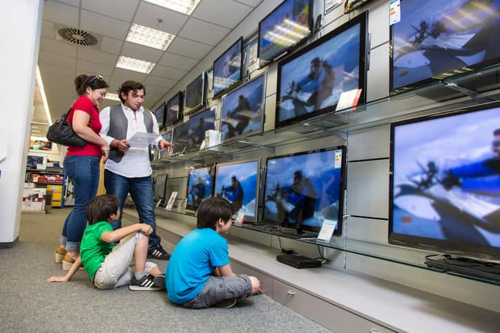 A family in an electronic goods showroom.