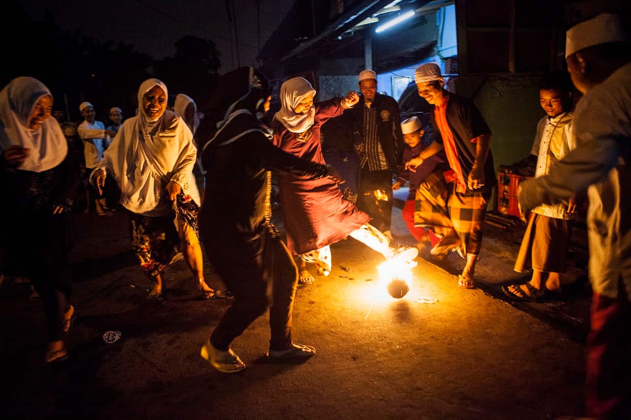 Residents of the subdistrict of Tebet play fire football to celebrate the beginning of the holy month of Ramadan on June 27, 2014 in Jakarta, Indonesia.